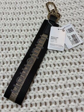 NWT lululemon black & gold never lost keychain